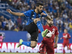 Montreal Impact defender Victor Cabrera kicks the ball away from Toronto FC forward Jordan Hamilton during second half Amway Canadian Championship semifinal action Wednesday,  June 8, 2016 in Montreal.