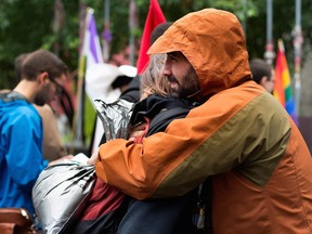 Mourners comfort each other at a vigil inParc de l’Espoir in Montreal on Sunday, June 12, 2016. The vigil was held for the Orlando Florida shooting victims.