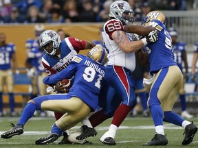 Winnipeg Blue Bombers' Adrian Hubbard (91) sacks Montreal Alouettes quarterback Kevin Glenn (5) during the first half of pre-season CFL action in Winnipeg Wednesday, June 8, 2016.