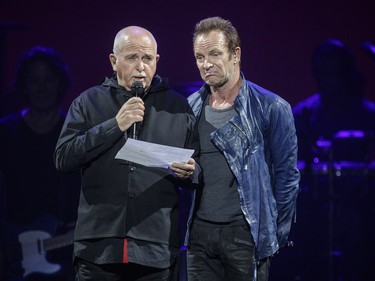 English musicians Peter Gabriel, left, and Sting, right, speak to the audience during their performance at the Bell Centre in Montreal as part of their Rock Paper Scissors tour on Tuesday, July 5, 2016.