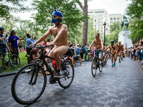 People take part in the Montreal World Naked Bike Ride at Dorchester Square in downtown Montreal on July 5, 2015.