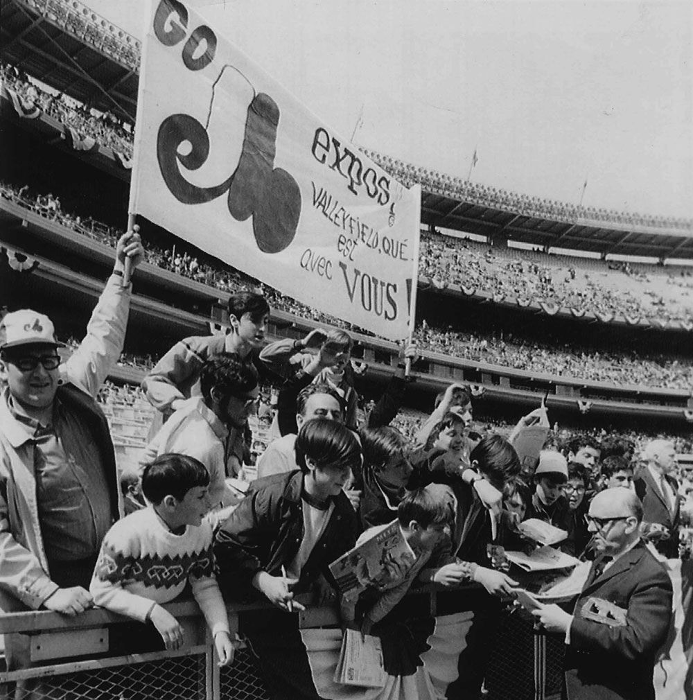 Autographs - Montreal Mayor Jean Drapeau signs autographs for Montreal Expo fans before the National League Expansion team took on the New York Mets in season opener in New York's Shea Stadium. AP wirephoto. 1969. Montreal Mayor Jean Drapeau (right) signs autographs for Expos fans before club took on the Mets April 8, 1969, in their season and franchise opener at New York's Shea Stadium.