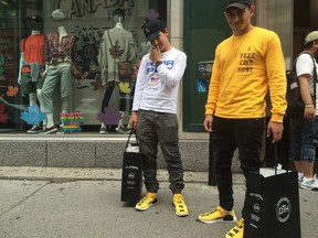 Antoine Nikolaidis, left and Gianni De Melo were among those who waited in line Friday, July 22, 2016 at Off The Hook store in downtown Montreal for a new Pharrell Williams x adidas NMD Human Race sneakers. The pair wasted no time wearing them.
