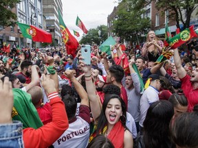 Soccer fans celebrate Portugal's victory over France in the UEFA Euro 2016 final on St. Laurent boulevard in Montreal on Sunday, July 10, 2016.