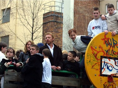 Tennis player Boris Becker and Nadia Comaneci talk to children at the Kick Project in Berlin in support of  the Laureus Sport for Good Foundation on March 12, 2001.