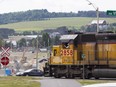 A train, traveling on the train line in Lac Mégantic, Qc. about 250 kms from Montreal Tuesday, June 28, 2016 that a train carrying cars with crude oil derailed from July 6, 2013, moves slowly through the reconstruction site in the community's central area. The resulting accident/fire in 2013 killed 47 people, destroyed much of downtown and polluted the environment.