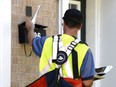 A postal worker delivers mail as an ongoing labour dispute between the Canadian Union of Postal Workers and Canada Post continues, Tuesday, July 5, 2016 in Ottawa.