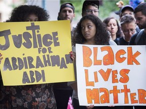 People gather in Montreal, Thursday, July 28, 2016, to denounce the death of Abdirahman Abdi in Ottawa.