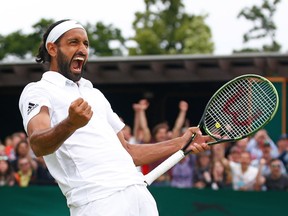 LONDON, ENGLAND - JULY 04:  Adil Shamasdin of Canada  (partner of Jonathan Marray of Great Britain) celebrates victory during the Men's Doubles first round match against Pablo Cuevas of Uraguay and Marcel Granollers of Spain on day seven of the Wimbledon Lawn Tennis Championships at the All England Lawn Tennis and Croquet Club on July 4, 2016 in London, England.