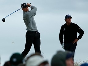 Henrik Stenson of Sweden, left, plays off the 13th tee watched by playing partner Phil Mickelson of the United States, centre, during the third round of the British Open Golf Championship at the Royal Troon Golf Club in Troon, Scotland, Saturday, July 16, 2016.