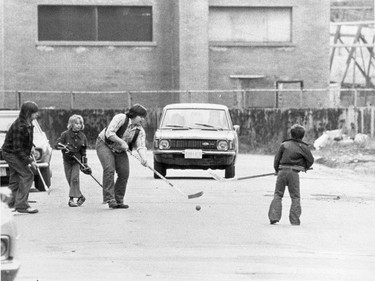 October 1976: Children play street hockey in Montreal.