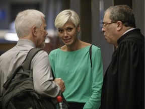 Psychiatrist Marie-Frédérique Allard, centre, speaks with Alan Guttman, right, defence lawyer in the trial of Richard Henry Bain, who is charged with the murder Denis Blanchette along with five other charges, at the courthouse in Montreal on Monday, July 25, 2016.