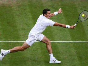 Milos Raonic of Canada plays a backhand during the Men's Singles third round match against Jack Sock of The United States on day six of the Wimbledon Lawn Tennis Championships at the All England Lawn Tennis and Croquet Club on July 2, 2016 in London, England.