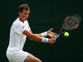 Vasek Pospisil of Canada plays a forehand during the Men's Singles first round match against Albert Ramos-Vinolas of Spain on day two of the Wimbledon Lawn Tennis Championships at the All England Lawn Tennis and Croquet Club on June 28, 2016 in London, England.