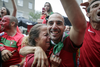 Soccer fans react in celebration after Portugal scored a goal over France in the UEFA Euro 2016 final as they watch at a bar on St. Laurent boulevard in Montreal on Sunday, July 10, 2016.