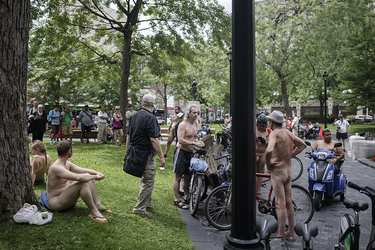 People gather for the World Naked Bike Ride at Dorchester Square in Montreal on Saturday, July 16, 2016. The World Naked Bike Ride event aims to encourage cycling, promote environmentalism, and address body image issues.