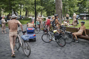 People gather to take part in the World Naked Bike Ride at Dorchester Square in Montreal on Saturday, July 16, 2016. The World Naked Bike Ride event aims to encourage cycling, promote environmentalism, and address body image issues.
