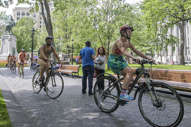 People take part in the World Naked Bike Ride at Dorchester Square in Montreal on Saturday, July 16, 2016. The World Naked Bike Ride event aims to encourage cycling, promote environmentalism, and address body image issues.
