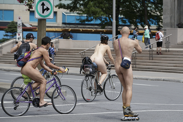 People take part in the World Naked Bike Ride at Dorchester Square in Montreal on Saturday, July 16, 2016. The World Naked Bike Ride event aims to encourage cycling, promote environmentalism, and address body image issues.
