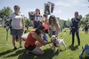 People pet a bull terrier as they gather at Pelican Park to protest against breed-specific legislation for dogs in Montreal on Saturday, July 16, 2016. The demonstration was against the recent proposed bans on pit bull dogs in Quebec after a series of high profile attacks.