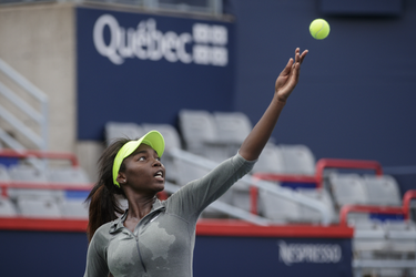 Canadian tennis player Françoise Abanda makes a serve during a practice session ahead of the Rogers Cup Tennis Tournament at Uniprix Stadium in Montreal on Friday, July 22, 2016.
