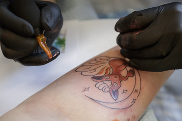 Ashley Gagnon gets a tattoo of the character Vulpix from tattoo artist Josi Labelle as part of a Pokemon Go promotion day at DFA Tattoos in Montreal on Sunday, July 24, 2016.