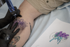 Pokemon fan Megan Muir gets a tattoo of the character Suicune from tattoo artist Melissa Valiquette as part of a Pokemon Go promotion day at DFA Tattoos in Montreal on Sunday, July 24, 2016.