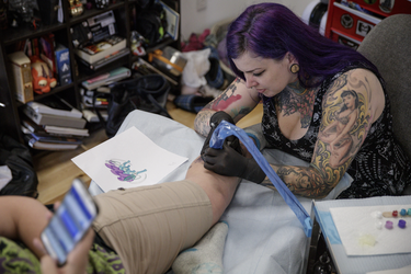 Pokemon fan Megan Muir gets a tattoo of the character Suicune from tattoo artist Melissa Valiquette as part of a Pokemon Go promotion day at DFA Tattoos in Montreal on Sunday, July 24, 2016.