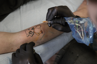 Pokemon fan Colin Lavigne gets a tattoo of the character Cubone from tattoo artist Angus Byers as part of a PokemonGo promotion day at DFA Tattoos in Montreal on Sunday, July 24, 2016.