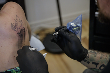 Pokemon fan Billie Prudence gets a tattoo of the character Leafeon from tattoo artist Yannis Panos as part of a PokemonGo promotion day at DFA Tattoos in Montreal on Sunday, July 24, 2016.