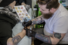 Pokemon fan Colin Lavigne gets a tattoo of the character Cubone from tattoo artist Angus Byers as part of a PokemonGo promotion day at DFA Tattoos in Montreal on Sunday, July 24, 2016.