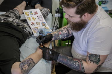 Pokemon fan Colin Lavigne gets a tattoo of the character Cubone from tattoo artist Angus Byers as part of a PokemonGo promotion day at DFA Tattoos in Montreal on Sunday, July 24, 2016.