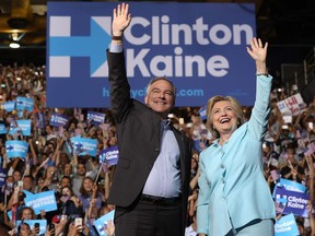 Presumptive Democratic presidential nominee Hillary Clinton and presumptive vice-presidential nominee Tim Kaine greet supporters during a campaign rally at Florida International University Panther Arena on July 23, 2016 in Miami.