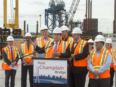 Mayor Denis Coderre speaks to the media at the site of the new Champlain Bridge Friday, July 8, 2016 in Montreal. Coderre said on the first anniversary of the start of construction that the project is on time and on budget.