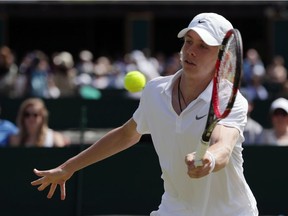 Denis Shapovalov of Canada plays a return to Yunseong Chung of Korea during their boy's singles match at Wimbledon July 6, 2016.