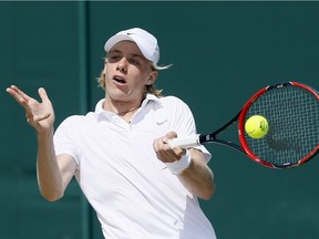 Denis Shapovalov of Canada returns to Mate Valkusz of Hungary during their men's singles match on day eleven of the Wimbledon Tennis Championships in London, Thursday, July 7, 2016.