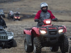 NDP Leader Tom Mulcair drives an ATV at the Sylvia Grinnell Territorial Park during a campaign stop in Iqaluit, Nunavut  on Tuesday, Sept. 29, 2015.