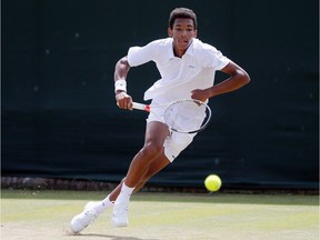Félix Auger-Aliassime of Montreal returns to Alex De Minaur of Australia during their boys' singles match at the Wimbledon Tennis Championships in London, Thursday, July 7, 2016.