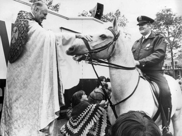 September 1976: Rev. Canon Horace Baugh blesses Gaillard, ridden by Const. Paul Laurin, at the blessing of the pets.