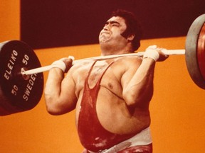 Soviet weightlifter Vasily Alekseyev strains beneath a barbell loaded with 255 kilograms (562 pounds) en route to winning the gold medal in the clean-and-jerk event at the 1976 Montreal Olympic Games on July 27, 1976. Alekseyev won the overall contest, combining the snatch lift and clean-and-jerk, by a remarkable 35 kg over East German silver medallist Gerd Bonk.