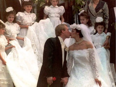 Nadia Comaneci and Bart Conner sealed their wedding with a kiss on the steps of Casin Monastery in Bucharest on April 27, 1996. The train of Comaneci's wedding dress is carried by six young Romanian gymnasts of the national team.