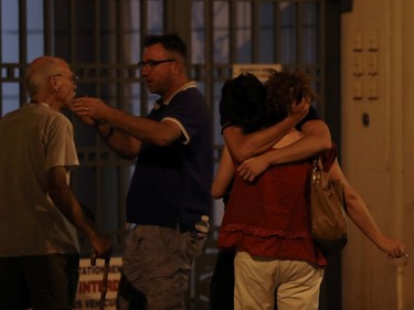 EDITORS NOTE: Graphic content / People react in the French Riviera town of Nice on July 15, 2016, after a van drove into a crowd watching a fireworks display. At least 60 people were killed when a truck ploughed into a crowd watching a Bastille Day fireworks display in the southern French resort of Nice, prosecutors said early on July 15. Nice prosecutor Jean-Michel Pretre said the truck drove two kilometres (1.3 miles) through a large crowd that was watching the fireworks.