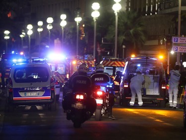 Police officers and rescue workers arrive at the scene of an attack on July 14, 2016, after a van ploughed into a crowd leaving a fireworks display in the French Riviera town of Nice. The mayor of the French city of Nice said dozens of people were likely killed after a van rammed into a crowd marking Bastille Day in the French Riviera resort today and urged residents to stay indoors.