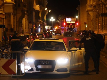 Police officers carry out checks on vehicles in the centre of French Riviera town of Nice, after a van drove into a crowd watching a fireworks display on July 14, 2016. At least 60 people are feared dead after a van drove into a crowd watching Bastille Day fireworks in the French resort of Nice on July 14, authorities said on July 15.