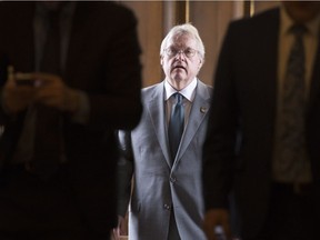 Quebec Health Minister Gaétan Barrette walks to a caucus meeting, Tuesday, April 12, 2016 at the legislature in Quebec City.