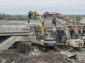 Construction crews demolish the St. Jacques street overpass at the Décarie Expressway on July 9.