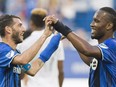 Montreal Impact's Ignacio Piatti, left, celebrates with teammate Didier Drogba after scoring against Sporting Kansas City during first half MLS soccer action in Montreal, Saturday, June 25, 2016.