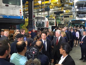 Prime Minister Justin Trudeau and Quebec Premier Philippe Couillard arrive at a press conference concerning public transit at the Centre de transport Stinson in Montreal, July 5, 2016.