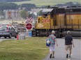 A train, traveling on the train line in Lac Mégantic, Qc. about 250 kms from Montreal Tuesday, June 28, 2016 that a train carrying cars with crude oil derailed from July 6, 2013, moves slowly through the reconstruction site in the community's central area. The resulting accident/fire in 2013 killed 47 people, destroyed much of downtown and polluted the environment.