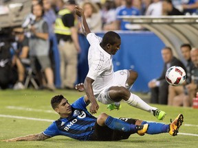 Montreal Impact's Lucas Ontivero, bottom, challenges Sporting Kansas City's Jimmy Medranda during second half MLS soccer action in Montreal, Saturday, June 25, 2016.